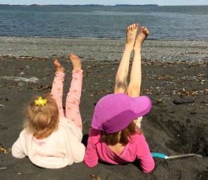 girls at beach legs in air